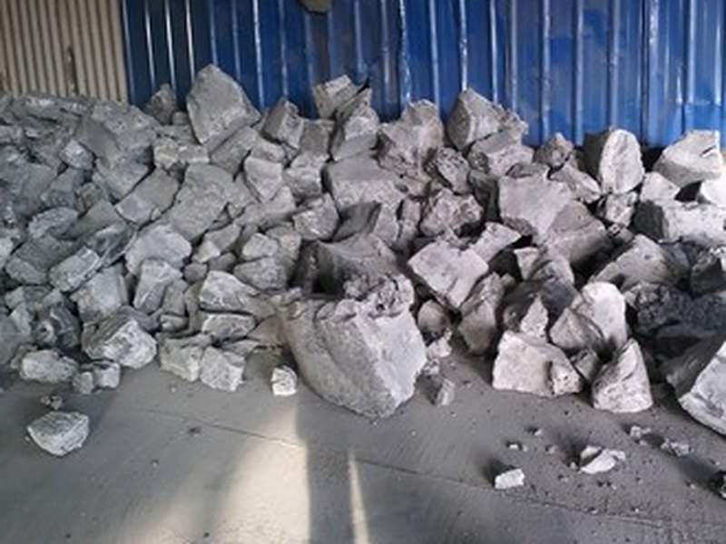 Petroleum coke loaded on a conveyor belt
