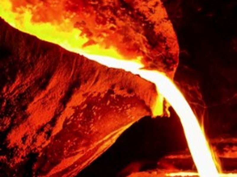 Molten metal pouring from a ladle into a mould